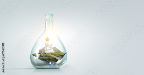 Business woman doing yoga in lotus pose inside glass bottle . Mixed media