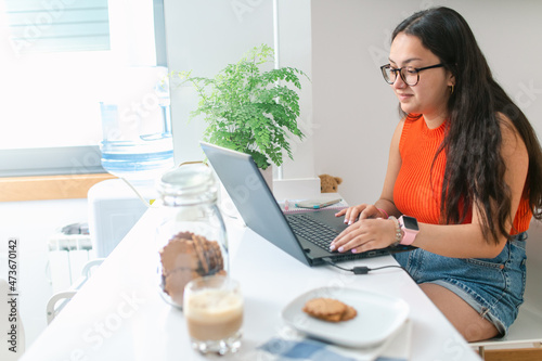 Brunette woman working from home photo