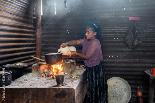 Young guatemalan woman preparing traditional food photo