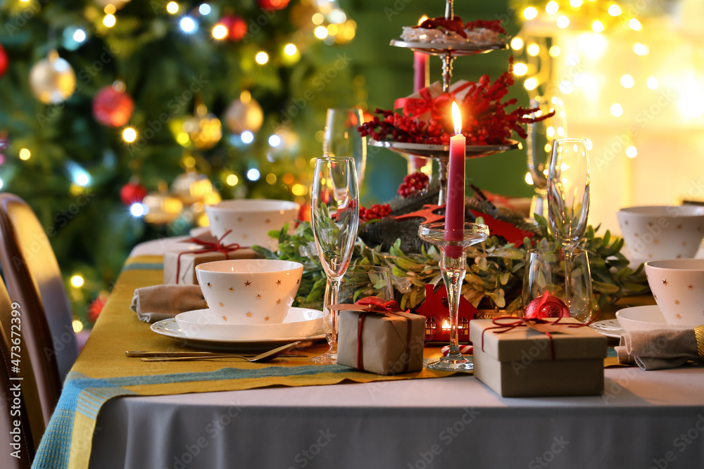 Dining table with beautiful setting in living room decorated for Christmas eve