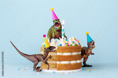 Dinosaurs eating a birthday cake photo