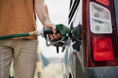 Close-up of Man refilling the fuel  tank in gas station
