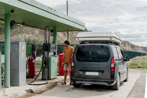 Man refilling the fuel  tank in gas station