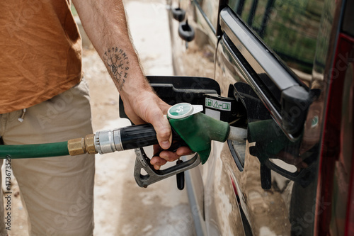 Close-up of Man refilling the fuel  tank in gas station