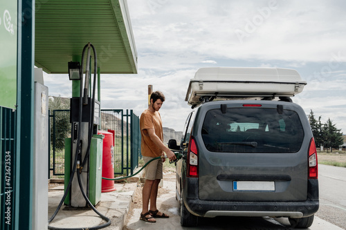 Man refilling the fuel  tank in gas station