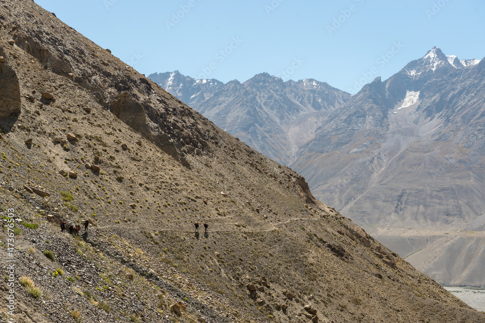 Porters on steep trail Porters on steep trail