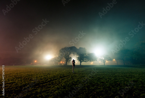 Female photographer during a foggy night