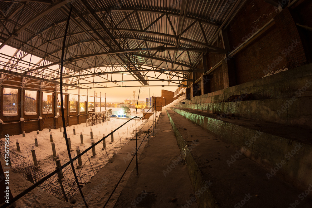 an abandoned stadium is illuminated at night in winter an abandoned stadium is illuminated at night in winter