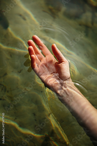 Hand in the water of a lake 