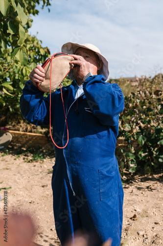 Farmer drinking beverage from bota bag