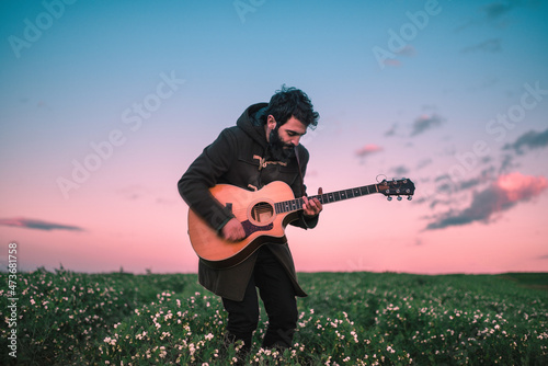 Guitarist playing outdoors  photo