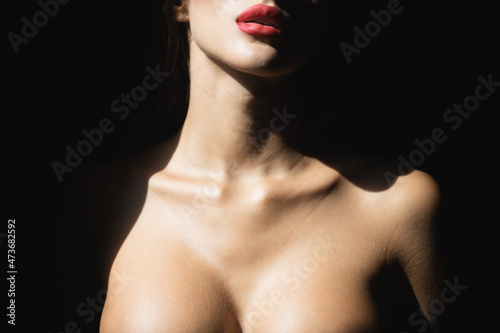 Sexy lips and tits boobs, breast. Beautiful young woman portrait on black. Sensual face of elegant female model in studio. Elegant lady. photo