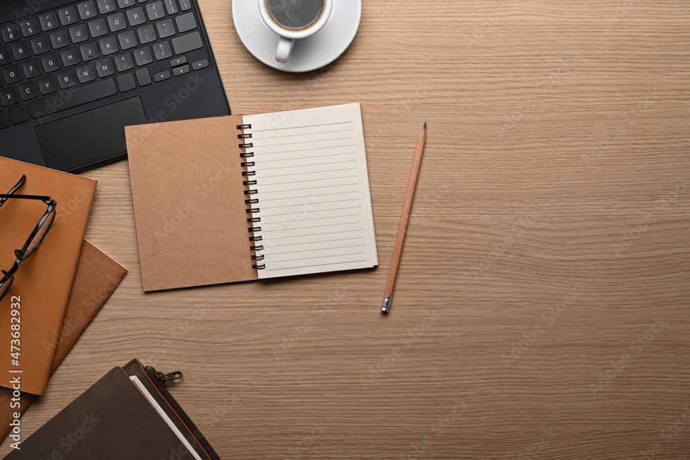 Top view stylish workplace with empty notebook, laptop computer and coffee cup. Top view stylish workplace with empty notebook, laptop computer and coffee cup.