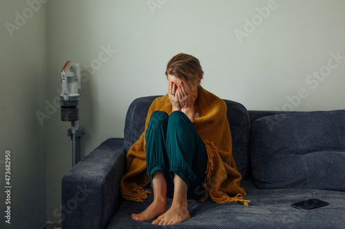 Upset woman sitting on couch