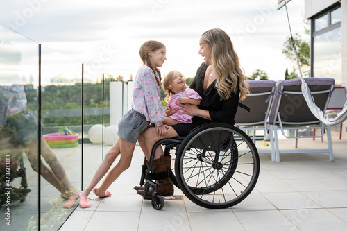 Portrait of mother in wheelchair with her daughters