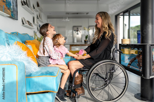 Mother in wheelchair playing with her daughter