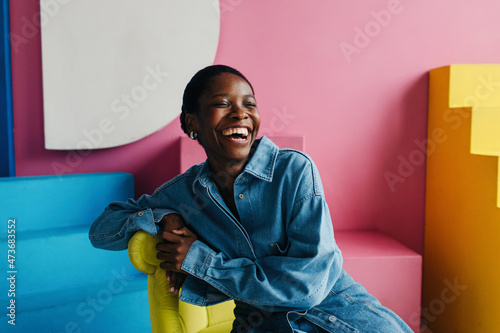 Happy black woman portrait in colorful interior photo