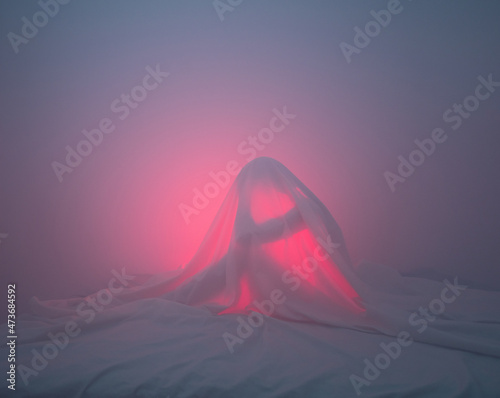 Worried woman under the sheets photo