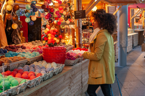 woman in christmas market buying garland, Europe photo