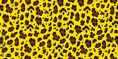 Leopard print on a yellow background. Seamless animalistic pattern.Vector hand-drawn background