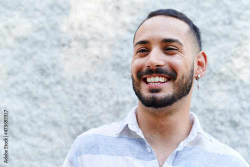 Young man laughing outside photo