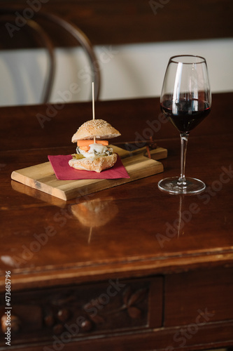 Still Life Of Red Wine And Finger Food On Wooden Table photo