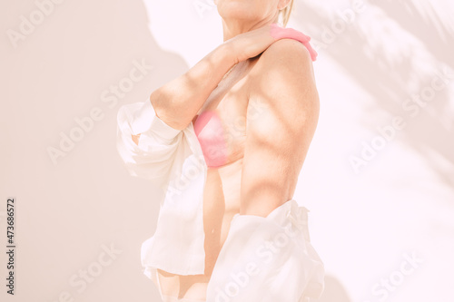 Half-naked woman with pink breast photo