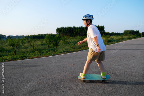 Asian woman playing skateboard