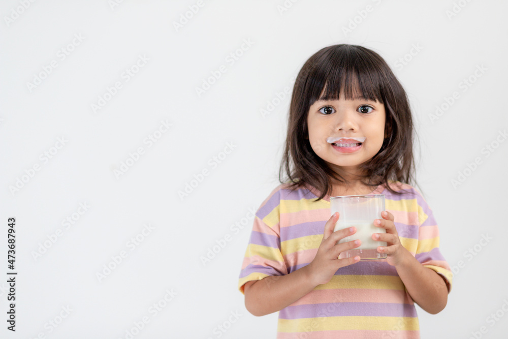 Smiling of Asian girl with a glass of milk