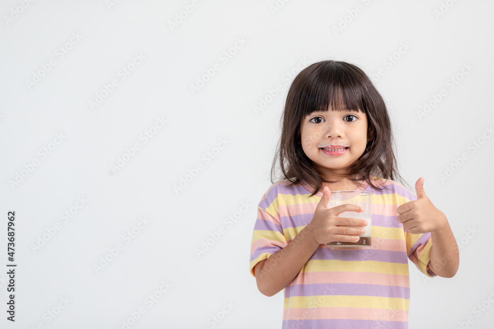 Smiling of Asian girl with a glass of milk Smiling of Asian girl with a glass of milk