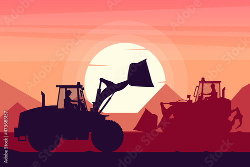 operators working with heavy machinery of track loader and front loader with a sunset in the background
