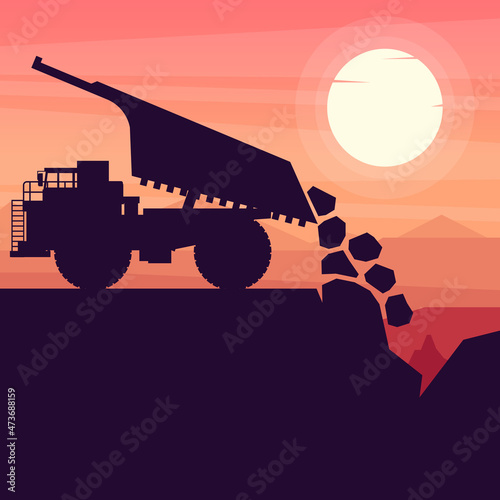 mining truck heavy machinery unloading materials in a mine with sunset background