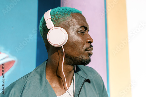 Black man listening to music in headphones