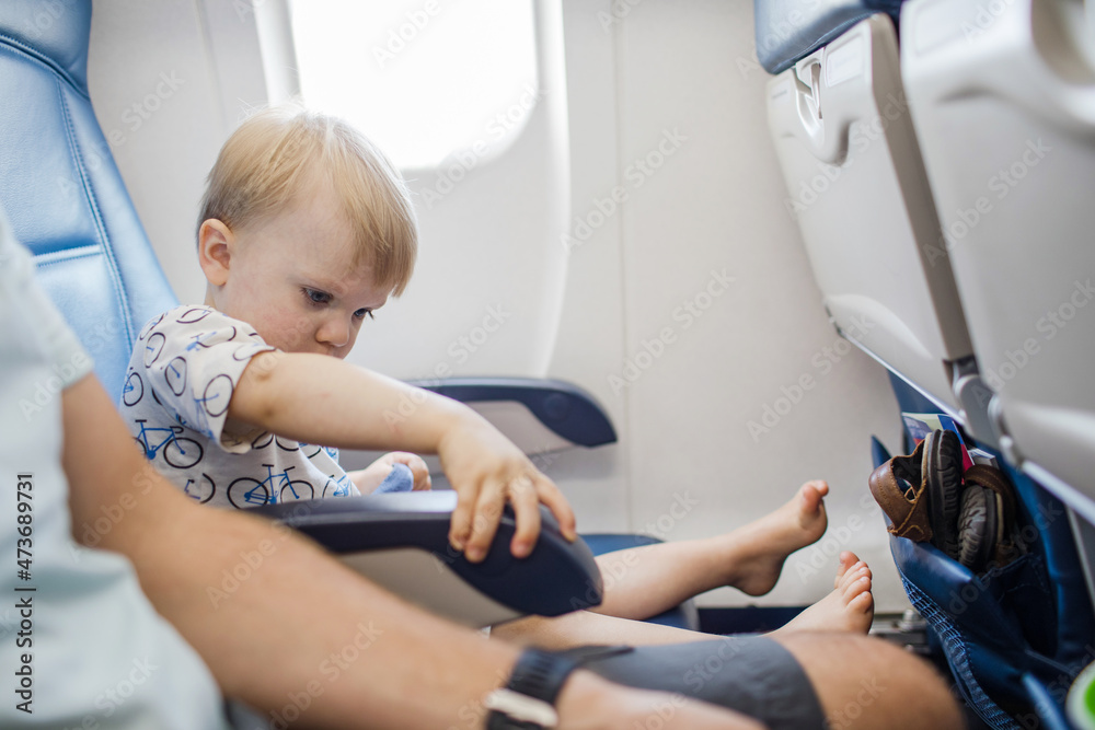 curious toddler on airplane curious toddler on airplane
