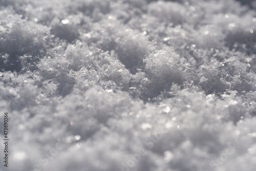 Background of fresh close up snow white texture. Fluffy snowflakes macro.