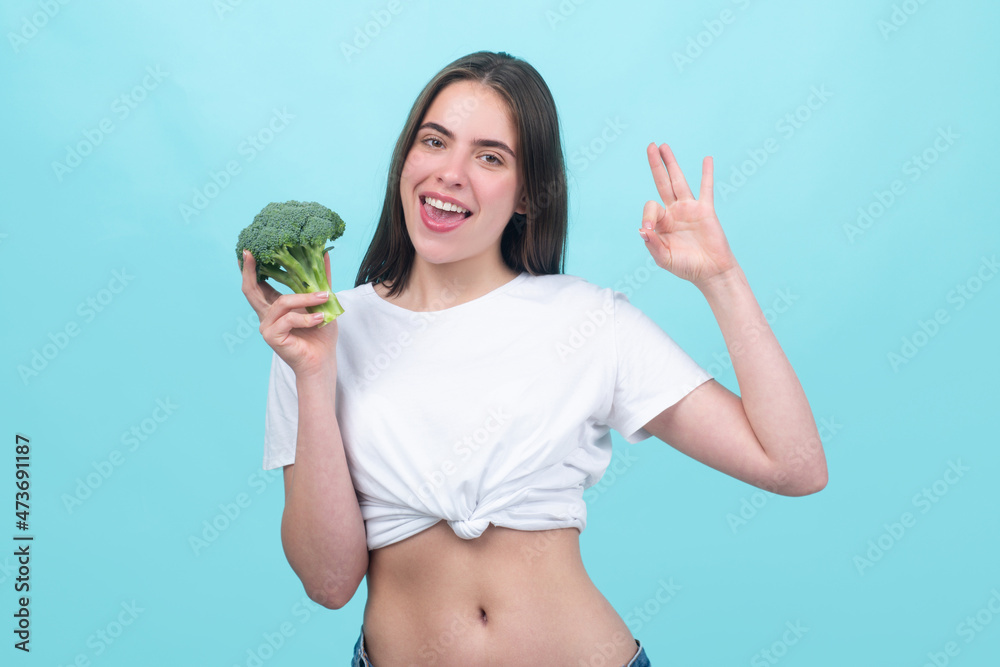 Happy woman holding product for dieting green broccoli. Isolated portrait. Healthy food, health life. Happy woman holding product for dieting green broccoli. Isolated portrait. Healthy food, health life.