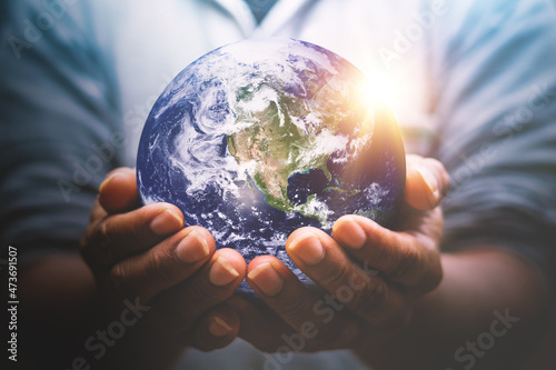 Fototapeta Naklejka Na Ścianę i Meble -  Hand of a man holding flying the earth, Energy and ecology concept, Elements of this image furnished by NASA.