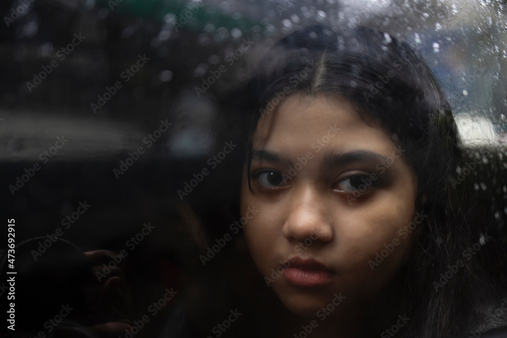 A teenage Indian girl with facial expressions inside car