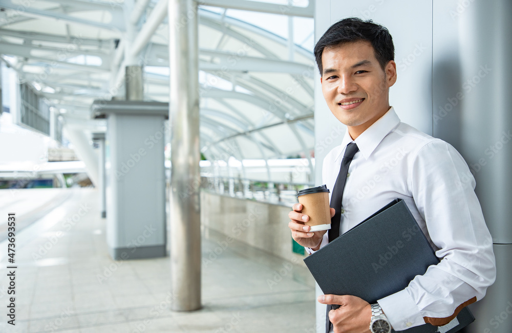 Businessman leadership hold document folder and drink cup of coffee outside near cityscape and dreaming for bigger projects with business assistants outside office. Finance portrait Businessman leadership hold document folder and drink cup of coffee outside near cityscape and dreaming for bigger projects with business assistants outside office. Finance portrait