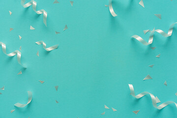 close up on group of white color of rolling ribbon and confetti on teal background with copy space for happy new year ,carnival , birthday and anniversary, concept design	