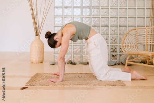 Woman Stretching At Marjariasana Pose photo