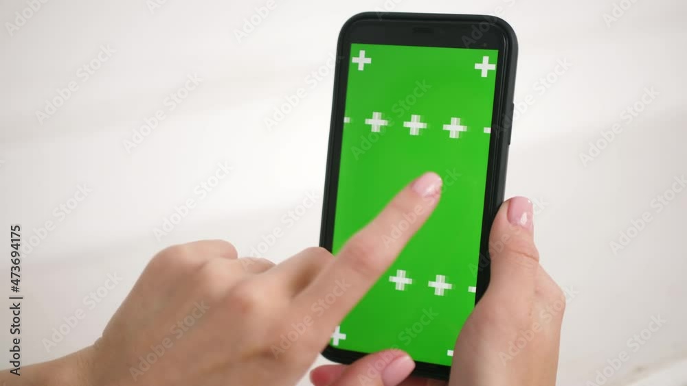 Video „Close up shots of green screen on iphone. Lady holding in hands