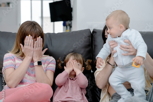 Mom and daugther covering their faces playing peekaboo