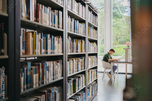 A man sitting and reading in library