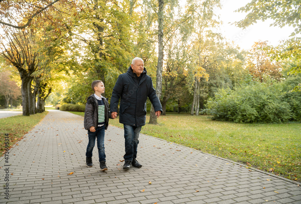 Grandad And Grandson Walking Outdoors Grandad And Grandson Walking Outdoors