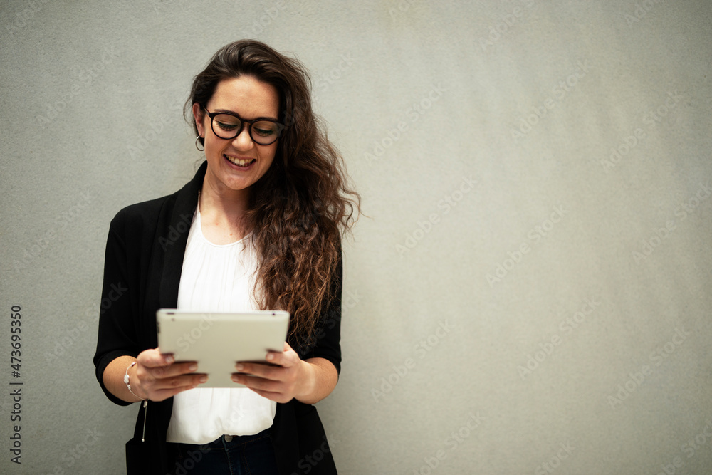 .Portrait of beautiful businesswoman holding digital tablet. Young student learning online... .Portrait of beautiful businesswoman holding digital tablet. Young student learning online...