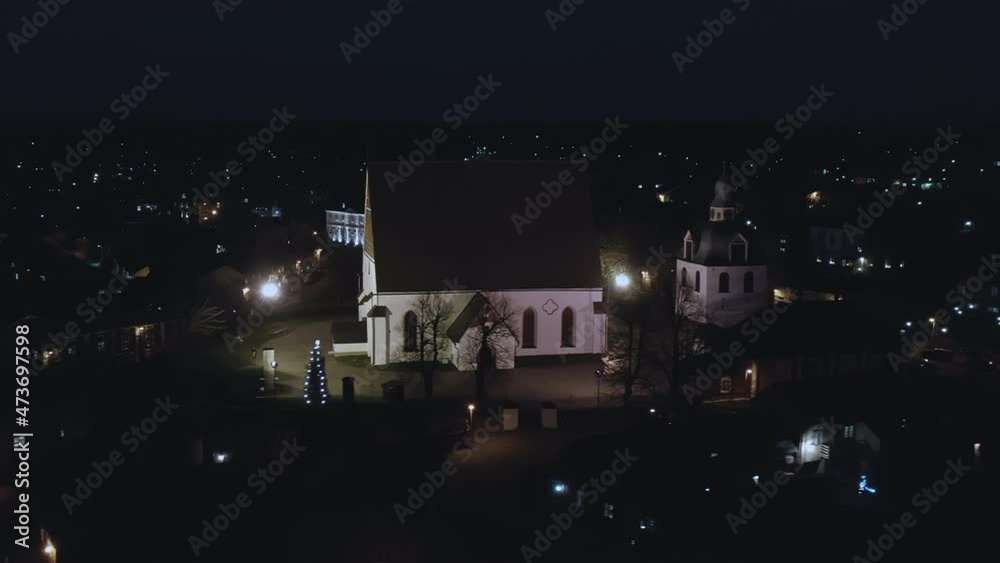 Porvoo.Finland-December 12.2020: Nighttime drone point of view of the Evangelical Lutheran Church in Porvoo. Aerial shot with the camera slowly moving sideways.