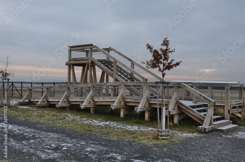 observation tower platform made of oak logs with barrier-free access for seniors and the immobile. zoo safari with a large paddock and terrace for tourists