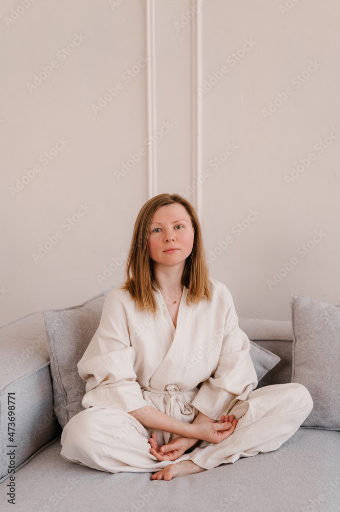 Woman in pajama on sofa
