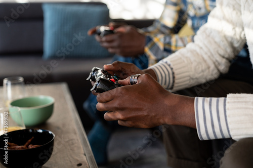 Anonymous Men Holding Gaming Consoles Indoor 